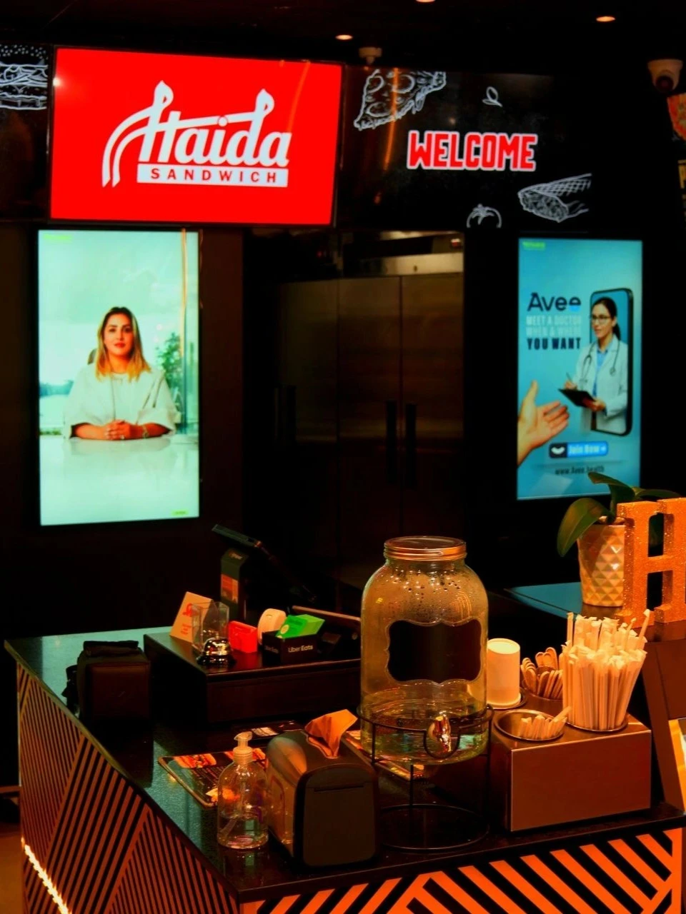 Two vertical screen advertising two diffrerent brands